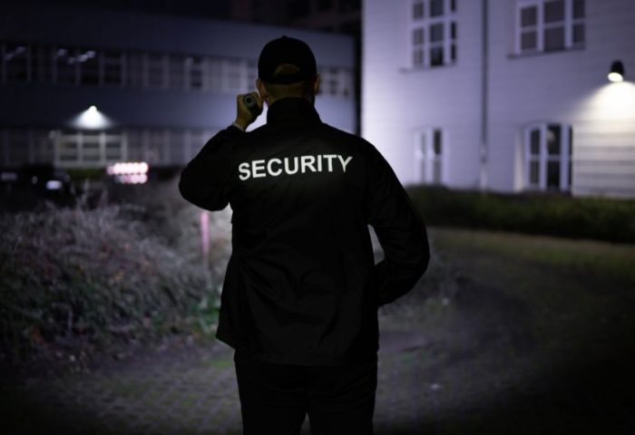 A security man with a flashlight-in-the-dark