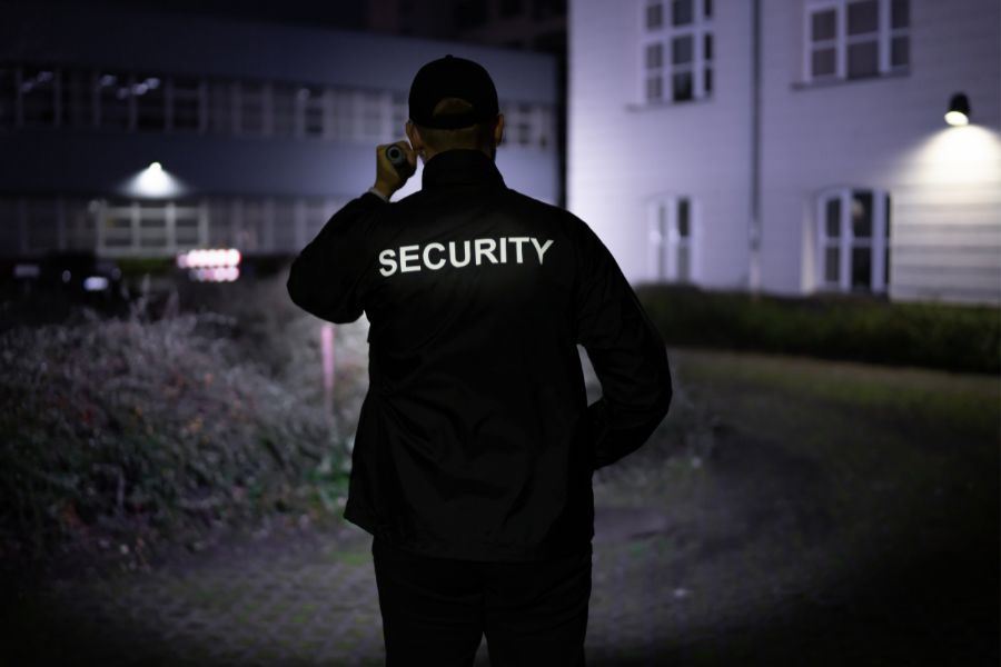 A security man with a flashlight-in-the-dark
